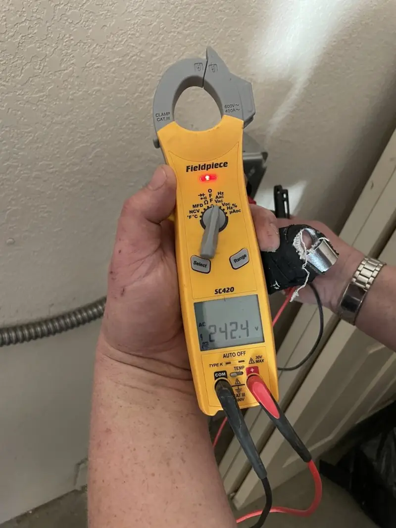 Voltage testing with clamp meter during Electrical Installation Services in Locust